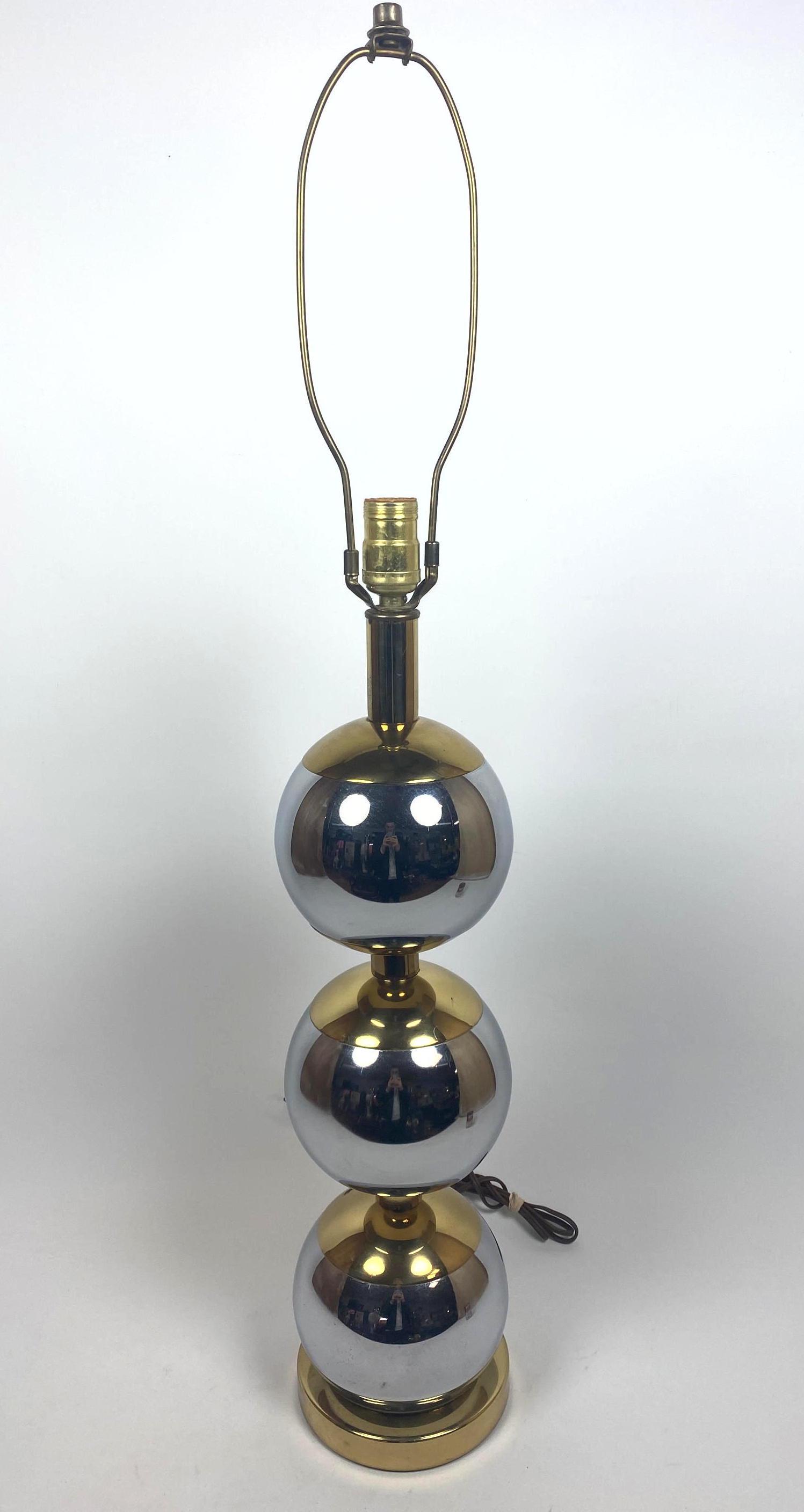 Kovacs style Stacked Chrome Ball Table Lamp. Brass cap: Kovacs style Stacked Chrome Ball Table Lamp. Brass cap accents. Shiny finish. -- Dimensions: H: 35 inches: W: 6 inches: D: 6 inches ---