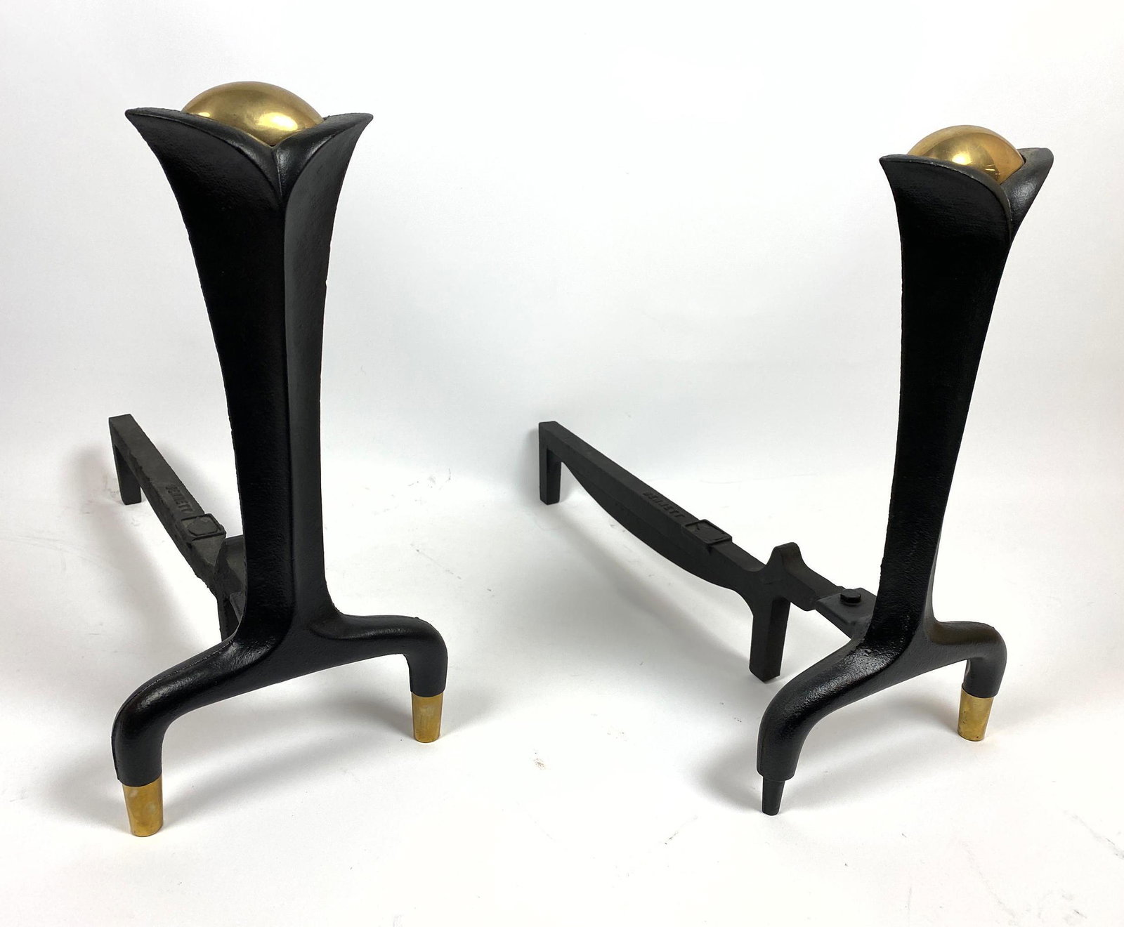 Pr DONALD DESKEY for WARD BENNETT Andirons. Modernist B: Pr DONALD DESKEY for WARD BENNETT Andirons. Modernist Black Iron forms with brass finial trim. Marked Bennett. -- Dimensions: H: 15.5 inches: W: 7.5 inches: D: 18.5 inches ---