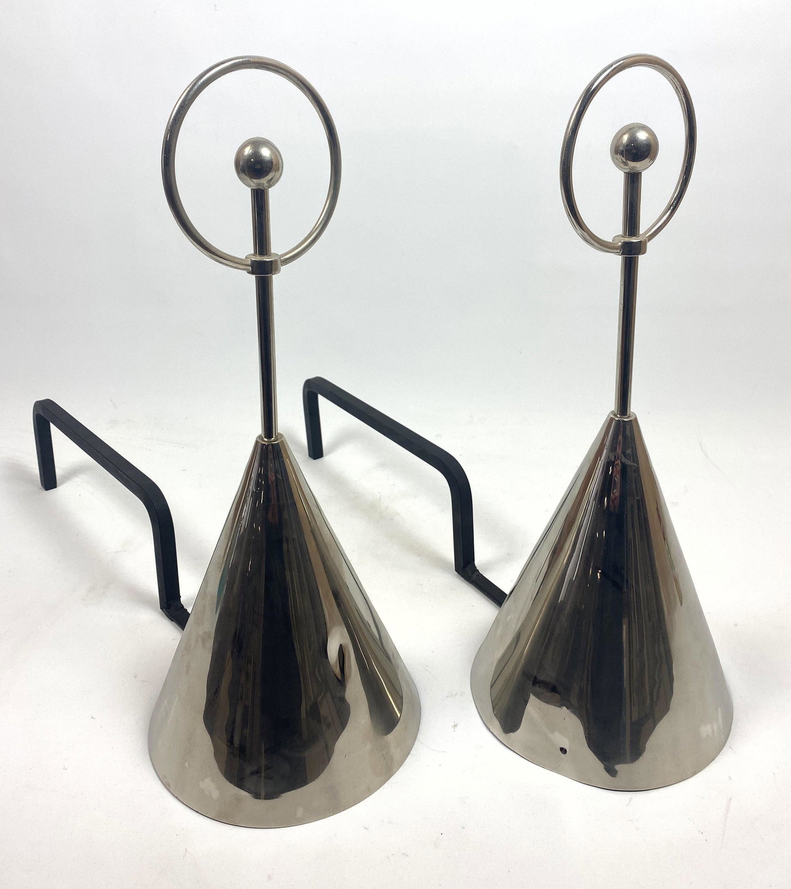 Modernist Chrome and Black Iron Andirons. Tapered cone: Modernist Chrome and Black Iron Andirons. Tapered cone form with sculptural detail.-- Dimensions: H: 17 inches: W: 7 inches: D: 16 inches ---