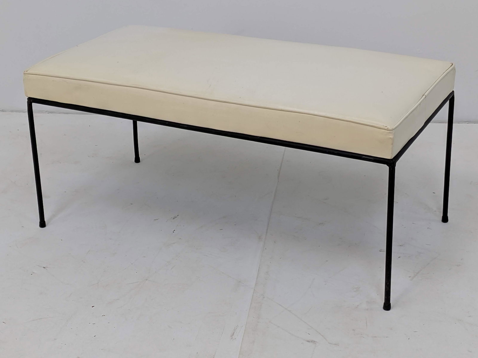 PAUL McCOBB Planner Group Black Iron Modernist Bench. O: PAUL McCOBB Planner Group Black Iron Modernist Bench. Off-white vinyl upholstery. Clean minimalist lines. -- Dimensions: H: 17 inches: W: 36 inches: D: 18 inches ---