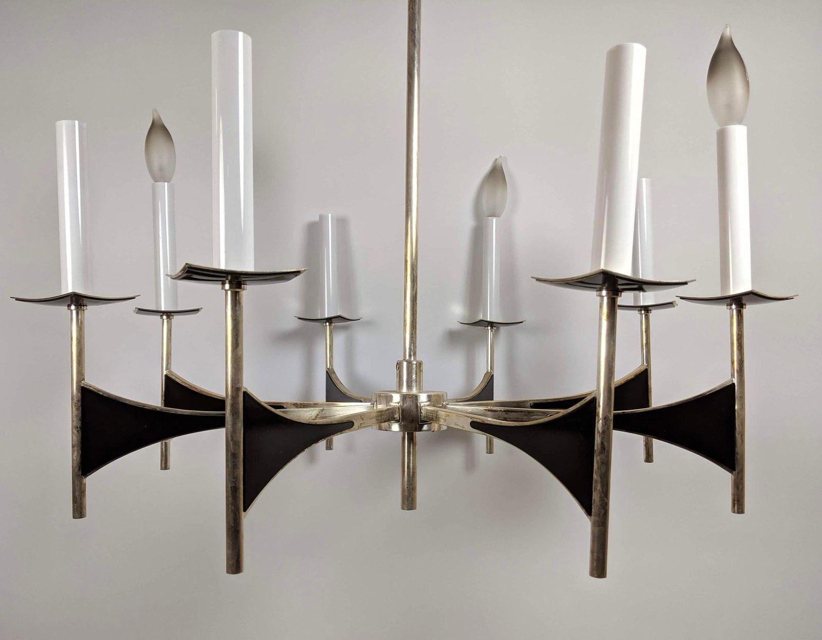 Modernist Don Drumm style Stainless Hanging Chandelier: Modernist Don Drumm style Stainless Hanging Chandelier. 8 Sculptural Arms. Black panel detail. Candelabra style. -- Dimensions: H: 31 inches: W: 26 inches: D: 26 inches ---