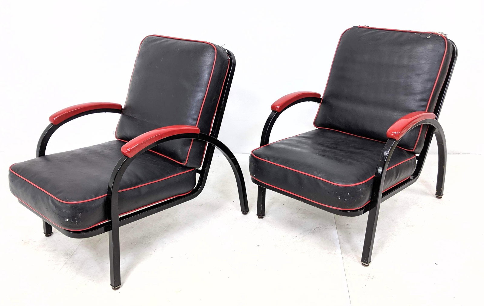 Pr Norman Bel Geddes for Simmons Deck Chairs: Pr Norman Bel Geddes for Simmons Deck Chairs Black & Red Metal Lounge Chairs. Vinyl cushions on metal black frame enamel red arms. -- Dimensions: H: 34 inches: W: 26 inches: D: 48 inches ---