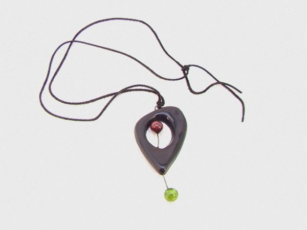 ACCOLAY Designer Pottery Necklace Pendant. Produce: ACCOLAY Designer Pottery Necklace Pendant. Produced in same area as Pablo Picasso Pottery. Mod Ceramic Art jewelry. Signed. On suede cord. Dimensions: H: 4 inches: W: 2 inches Condition: Very Good Con