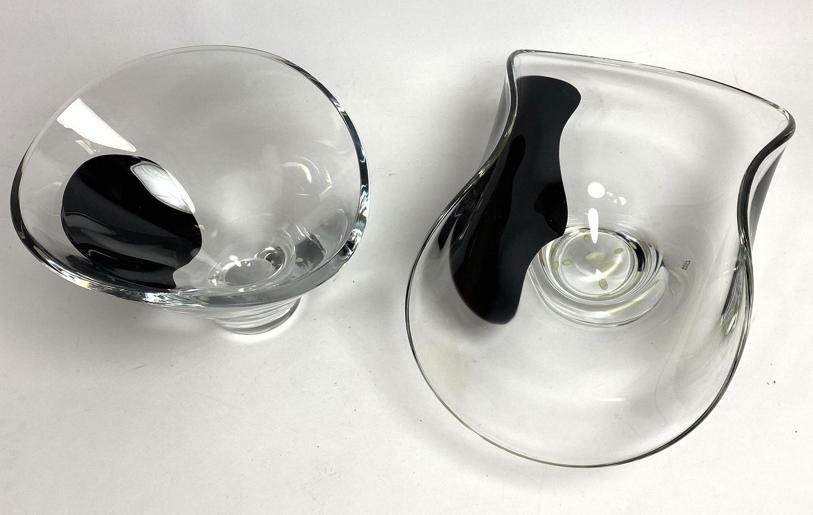 2pc GORAN WARFF for KOSTA BODA Art Glass Bowls. Moderni: 2pc GORAN WARFF for KOSTA BODA Art Glass Bowls. Modernist clear forms with single dark purple accents. Both signed and labeled.-- Dimensions: H: 6.25 inches: W: 15.5 inches: D: 8 inches ---