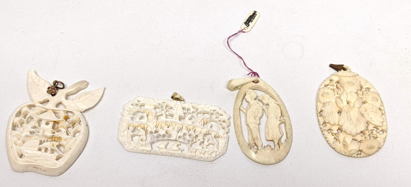4 Carved Pendants. Carved Apple with interior scene. Ov: 4 Carved Pendants. Carved Apple with interior scene. Oval pendant with iris and daisies. Two scenic pendants. Very good condition light wear. -- Dimensions: --- US Shipping charge: $35 Plus insurance 