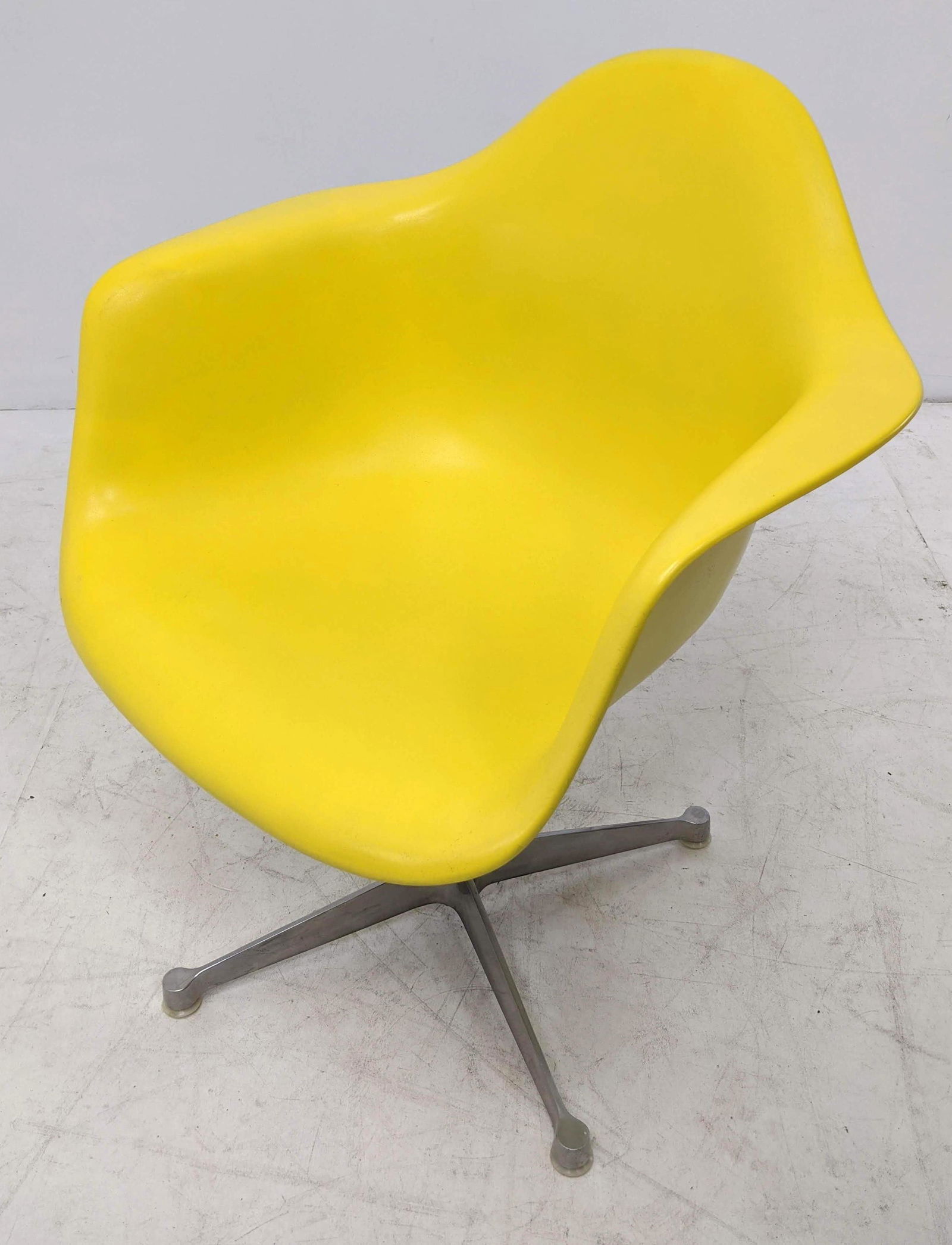 CHARLES EAMES Fiberglass Swivel Arm Chair for HERMAN M: CHARLES EAMES Fiberglass Swivel Arm Chair for HERMAN MILLER. Contract base. Marked.-- Dimensions: H: 32 inches: W: 25 inches: D: 22 inches ---