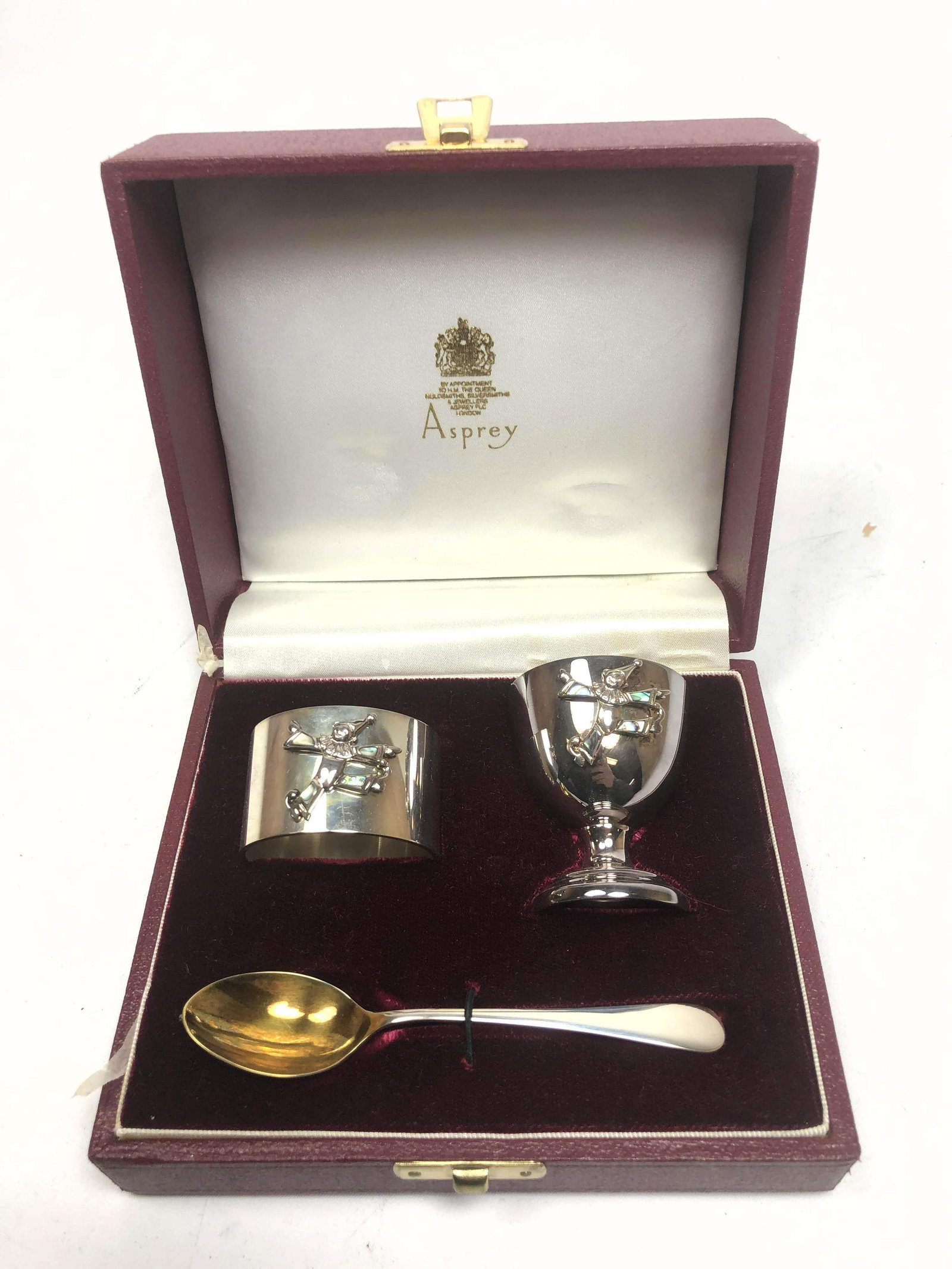 ASPREY Sterling Set with Egg Cup, Napkin Ring, Teaspoon: ASPREY Sterling Set with Egg Cup, Napkin Ring, Teaspoon. Clown design on napkin ring and cup, inlaid with mother of pearl. Hallmarked. -- Dimensions: H: 2.25 inches: W: 1.75 inches--- Weight: 4.04 Tro