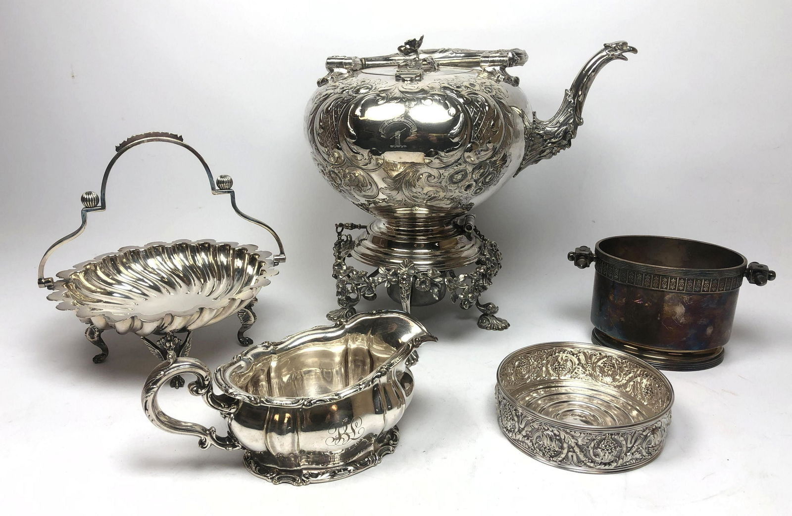 5pc Silver Plate Set Incl. Tilting Teapot Kettle. 1) Hi: 5pc Silver Plate Set Incl. Tilting Teapot Kettle. 1) Highly decorative animal spout tilting teapot. 2) TIFFANY and Co. wine coaster. 3) Gravy boat. 4) Handled candy dish. 5) Spooner.-- Dimensions: H:
