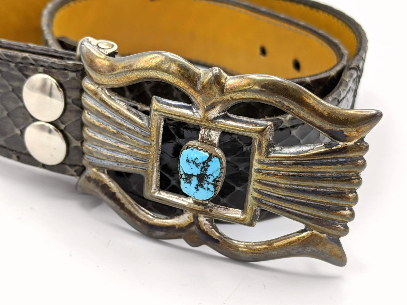 N. TSO Silver Turquoise Belt Buckle. Heavy cast silver: N. TSO Silver Turquoise Belt Buckle. Heavy cast silver buckle with central turquoise nugget element. Gray snakeskin leather belt. Buckle is marked and measures 3.25" x 2". -- Dimensions: : L: 35 inche