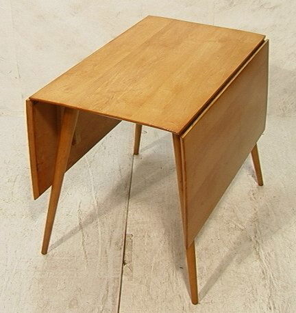 Paul McCobb Planner Group Drop Side Table. Dining: Paul McCobb Planner Group Drop Side Table. Dining Table with Tapered Legs. Unmarked. Dimensions: H: 29 inches: W: 23.5 inches: D: 36 inches Condition (General) Please contact us for a detailed conditi