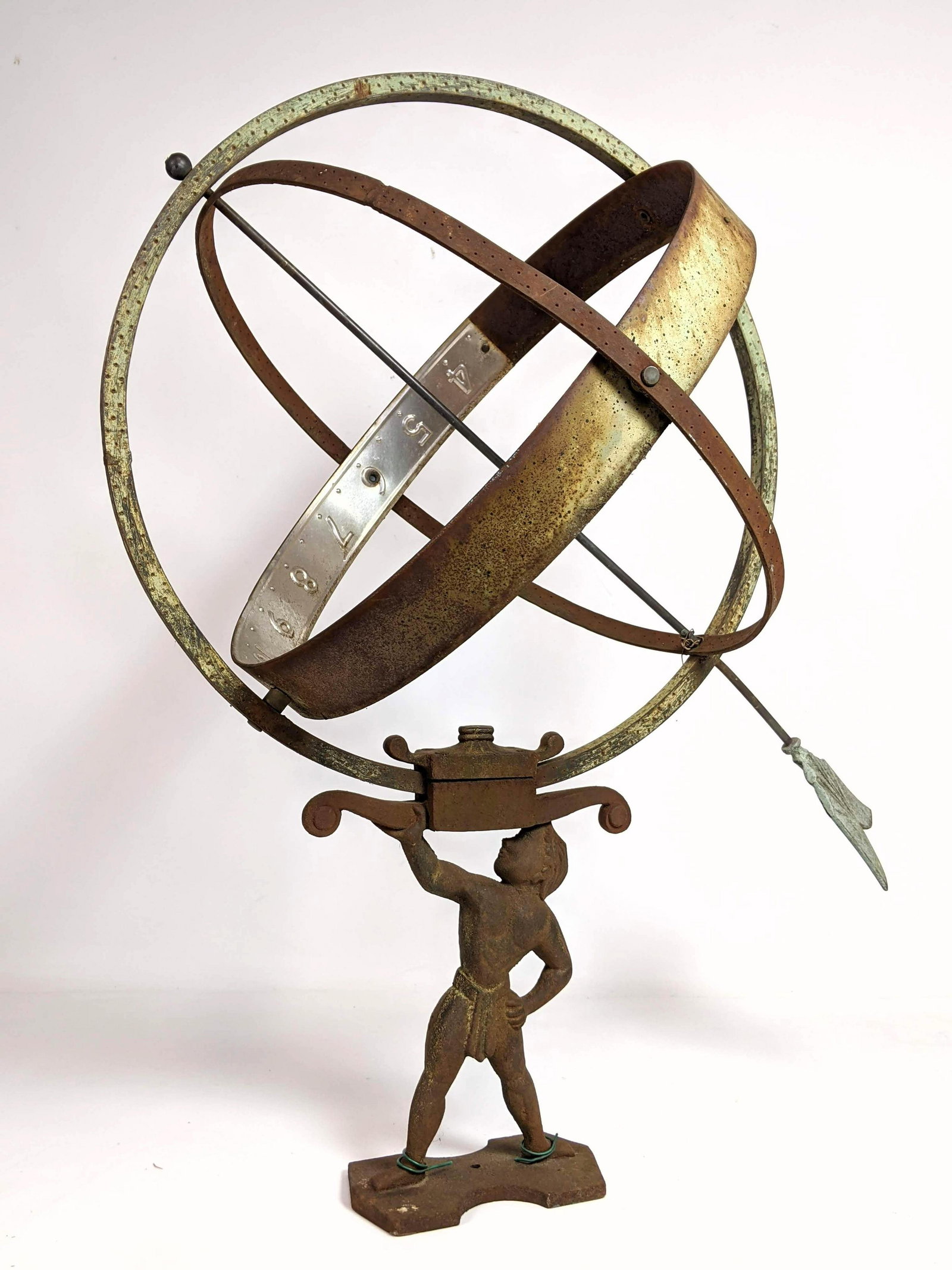 Iron and Tin Armillary Sun Supported by Figure. Dial: Iron and Tin Armillary Sun Supported by Figure. Dial-- Dimensions: H: 28 inches: W: 16 inches ---