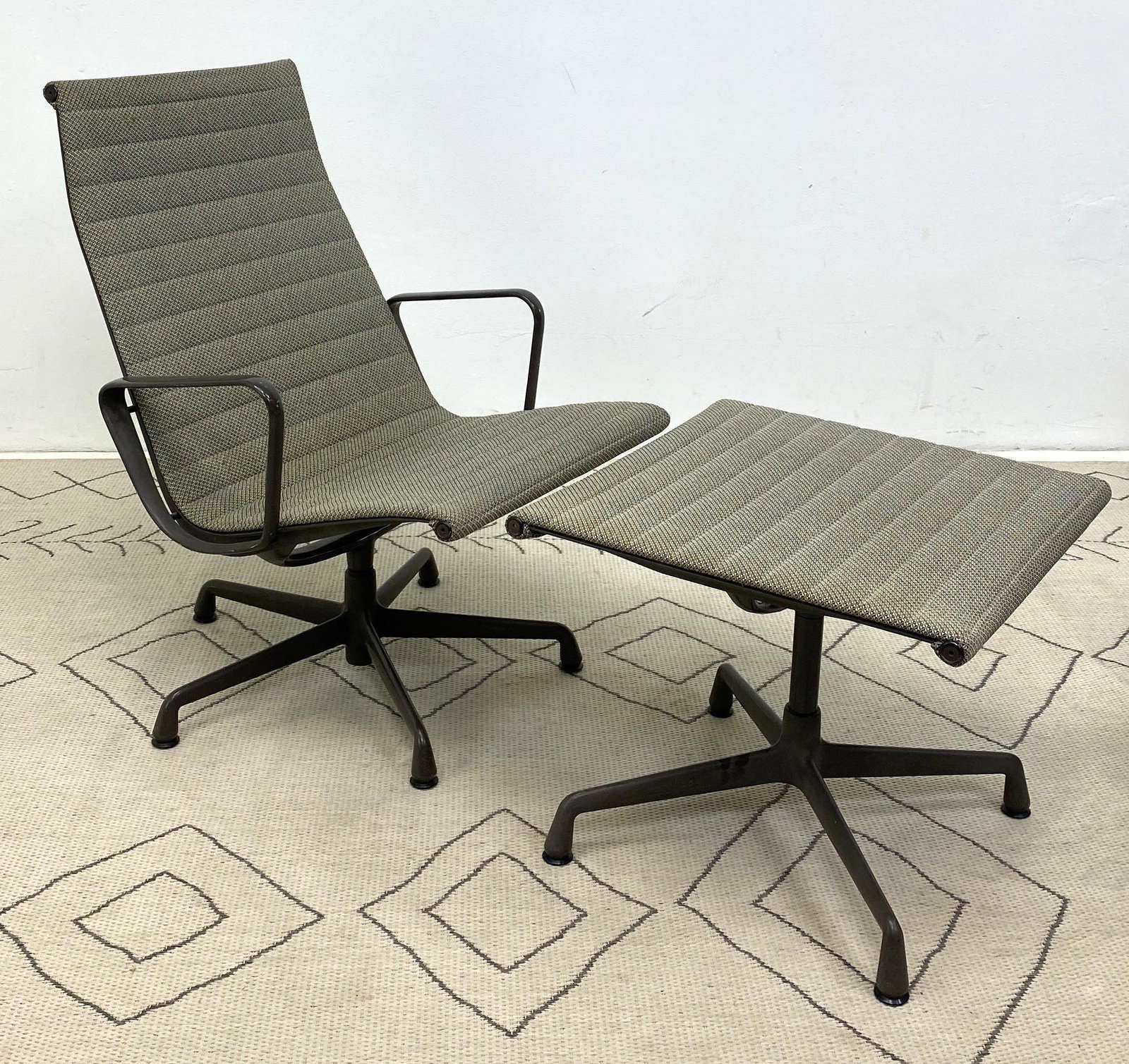 Herman Miller Aluminum Group Lounge Chair and Ottoman.: Herman Miller Aluminum Group Lounge Chair and Ottoman. Brown Finish.-- Dimensions: H: 34 inches: W: 24.5 inches: D: 27 inches ---