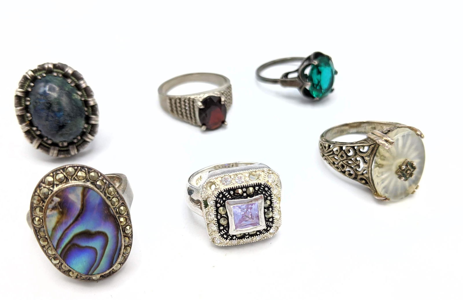 Lot of 6 Silver Ladies Rings. One camphor glass style i: Lot of 6 Silver Ladies Rings. One camphor glass style in filigree setting. Abalone marcasite ring, etc. -- Dimensions: --- Weight: 1.28 Troy ozs. ---- --- US Shipping charge: $15 Plus insurance at a r