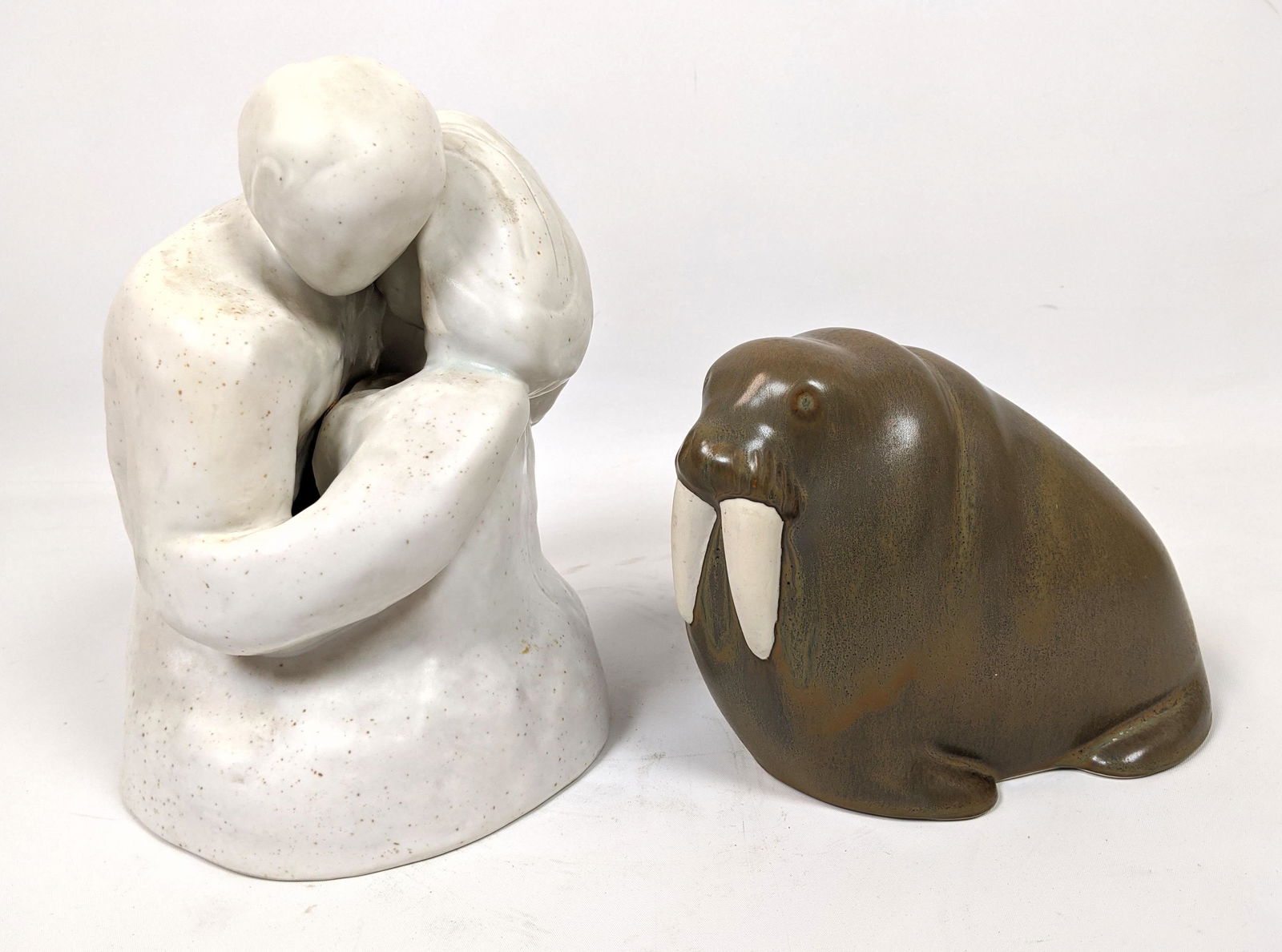 2pcs Figural Art Pottery Sculptures. Royal Copenhagen G: 2pcs Figural Art Pottery Sculptures. Royal Copenhagen Gallery 5432 HENRY HEERUP embracing couple 95/500 and Unmarked Nicely Glazed Walrus. -- Dimensions: H: 9 inches: W: 7 inches: D: 6 inches ---