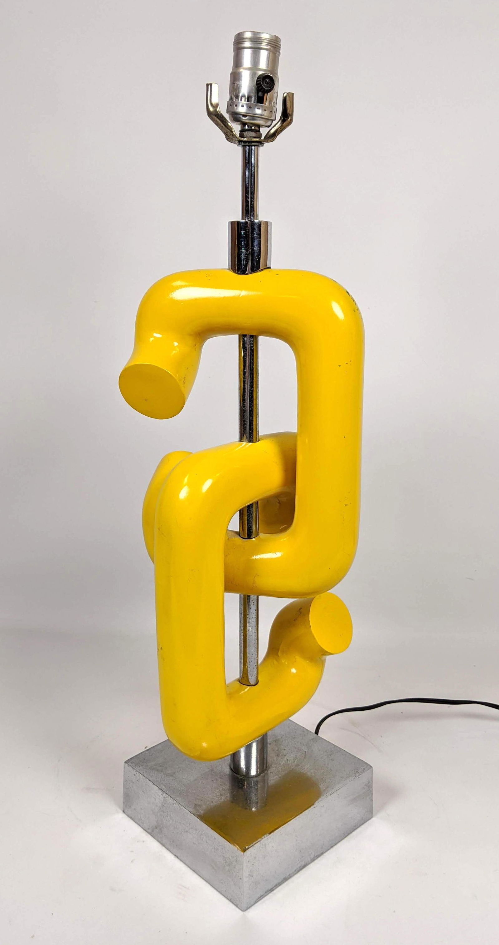 ROBERT SONNEMAN OP ART TABLE LAMP. Interlocked yellow: ROBERT SONNEMAN OP ART TABLE LAMP. Interlocked yellow Links with chrome base. -- Dimensions: H: 24.5 inches: W: 7 inches: D: 7 inches ---