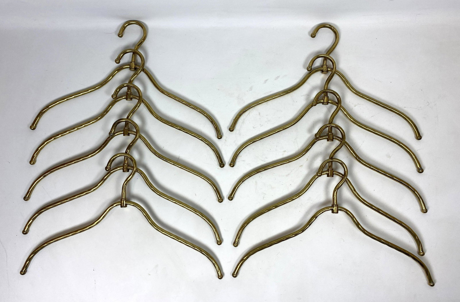 Set 10 Clothes Hangers. Italian Style. Twisted Brass To: Set 10 Clothes Hangers. Italian Style. Twisted Brass Tone. Hollywood regency Ponti Style. Marked Italy. -- Dimensions: H: 11 inches: W: 18 inches --- US Shipping charge: $35 Plus insurance at a rate o