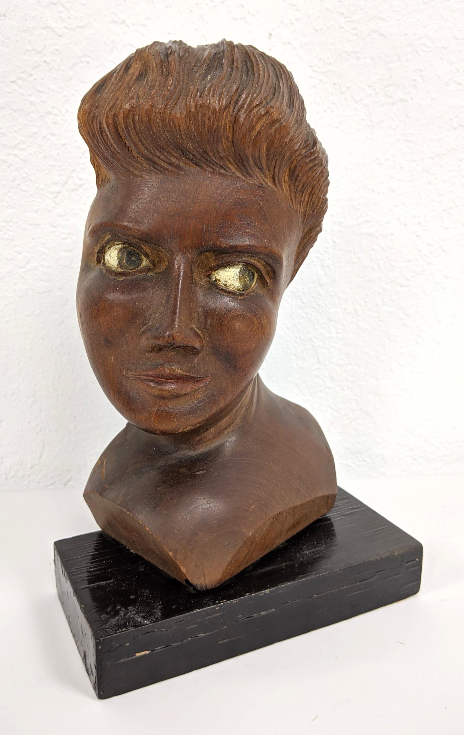 Carved Wood Bust Woman. Painted expressive eyes. Eboniz: Carved Wood Bust Woman. Painted expressive eyes. Ebonized wood base. Not marked-- Dimensions: H: 13 inches: W: 8 inches: D: 4 inches ---