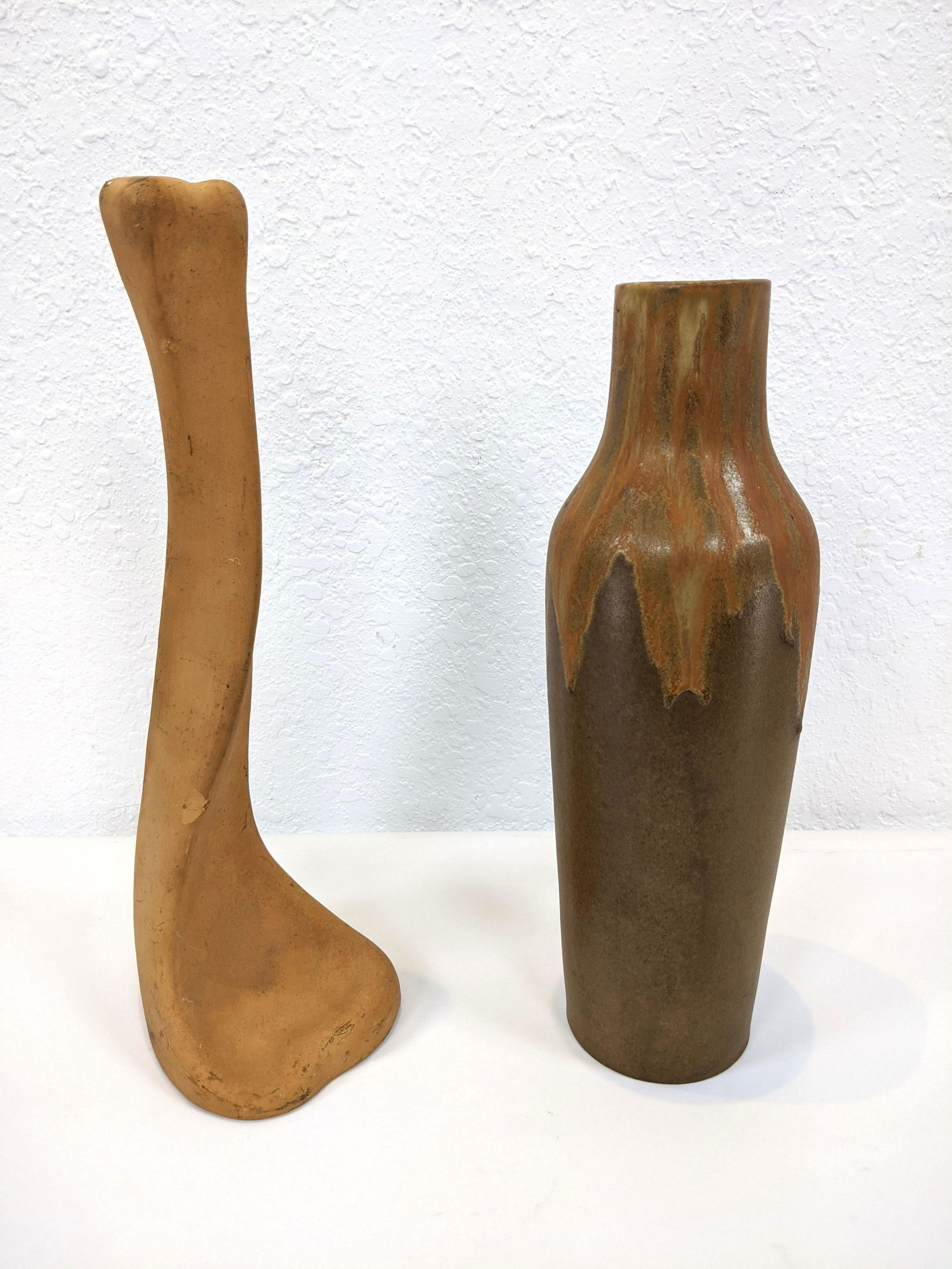 2pc 20th Century Pottery Lot. 1) ELSA PERETTI for TIFFA: 2pc 20th Century Pottery Lot. 1) ELSA PERETTI for TIFFANY Terracotta ÒBoneÓ Candle Stick. 2) DENBAC French glazed pottery vase. Orange drip glaze on brown body. Both marked-- Dimensions: H: 14.25 in
