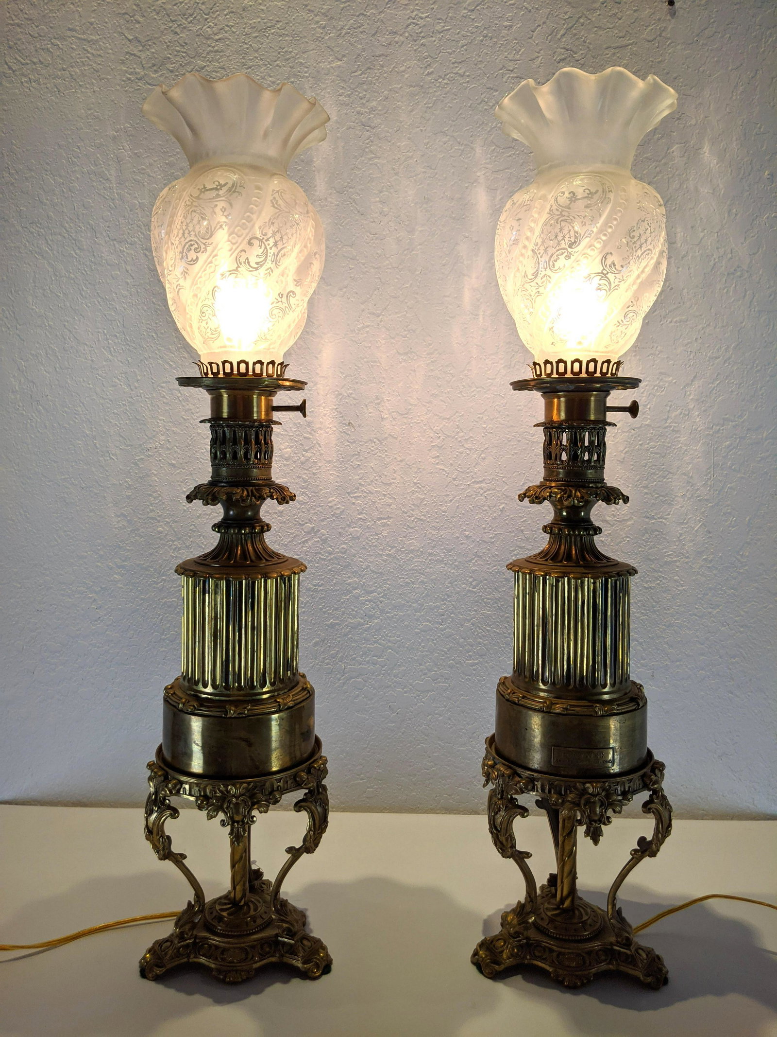 Pr FONTAINE Brass Converted Oil Lamps. Stepped cylindri: Pr FONTAINE Brass Converted Oil Lamps. Stepped cylindrical form on decorative open base. Flared glass hurricane shades. Marked Fontaine w French Business Addres-- Dimensions: H: 28.5 inches: W: 7 inch