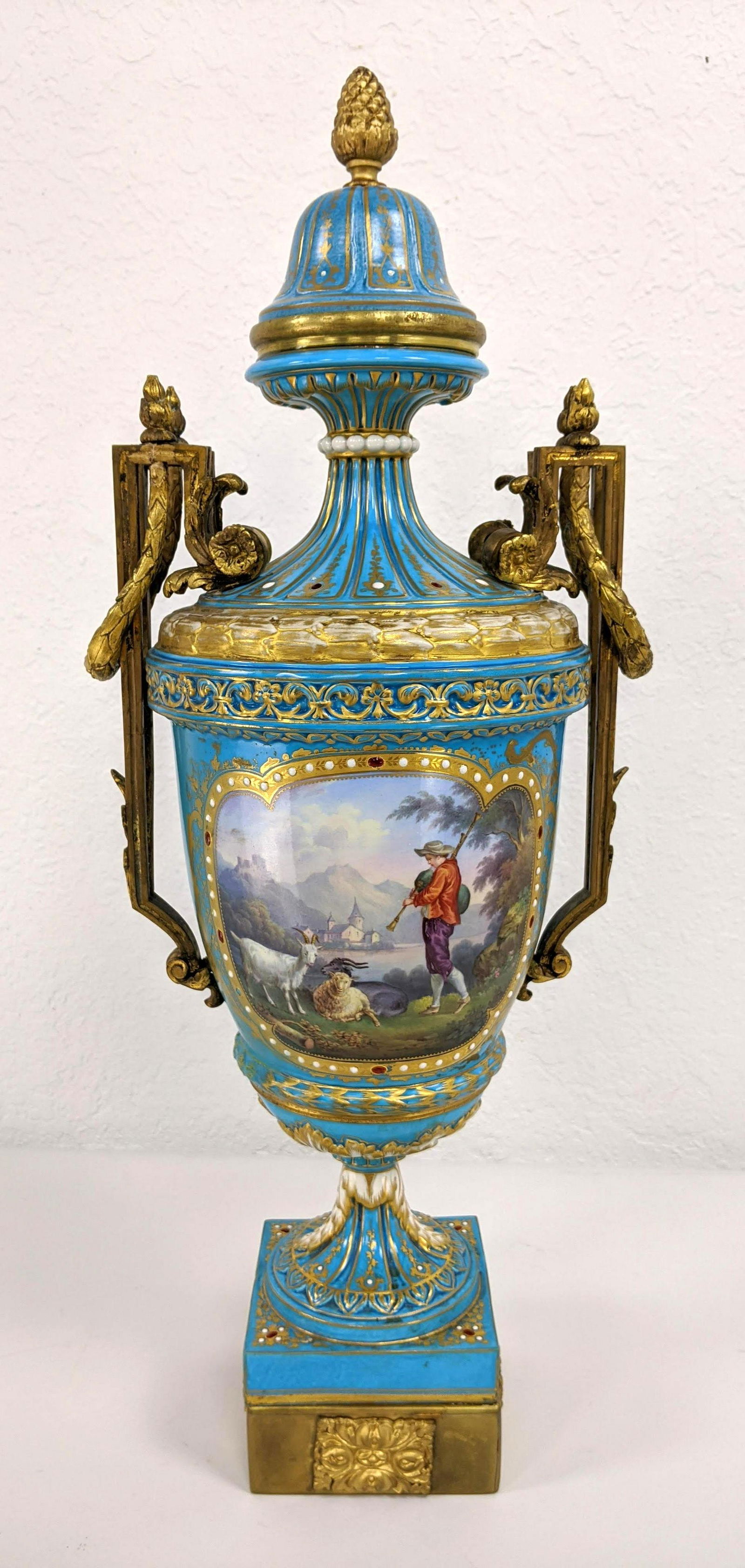 SEVRES French Antique Porcelain Lidded Urn. Gilt bronze: SEVRES French Antique Porcelain Lidded Urn. Gilt bronze ormolu mounts. Turquoise body with two scenic medallions. Sevres mark S. 41 France-- Dimensions: H: 22 inches: W: 10 inches: D: 7 inches ---