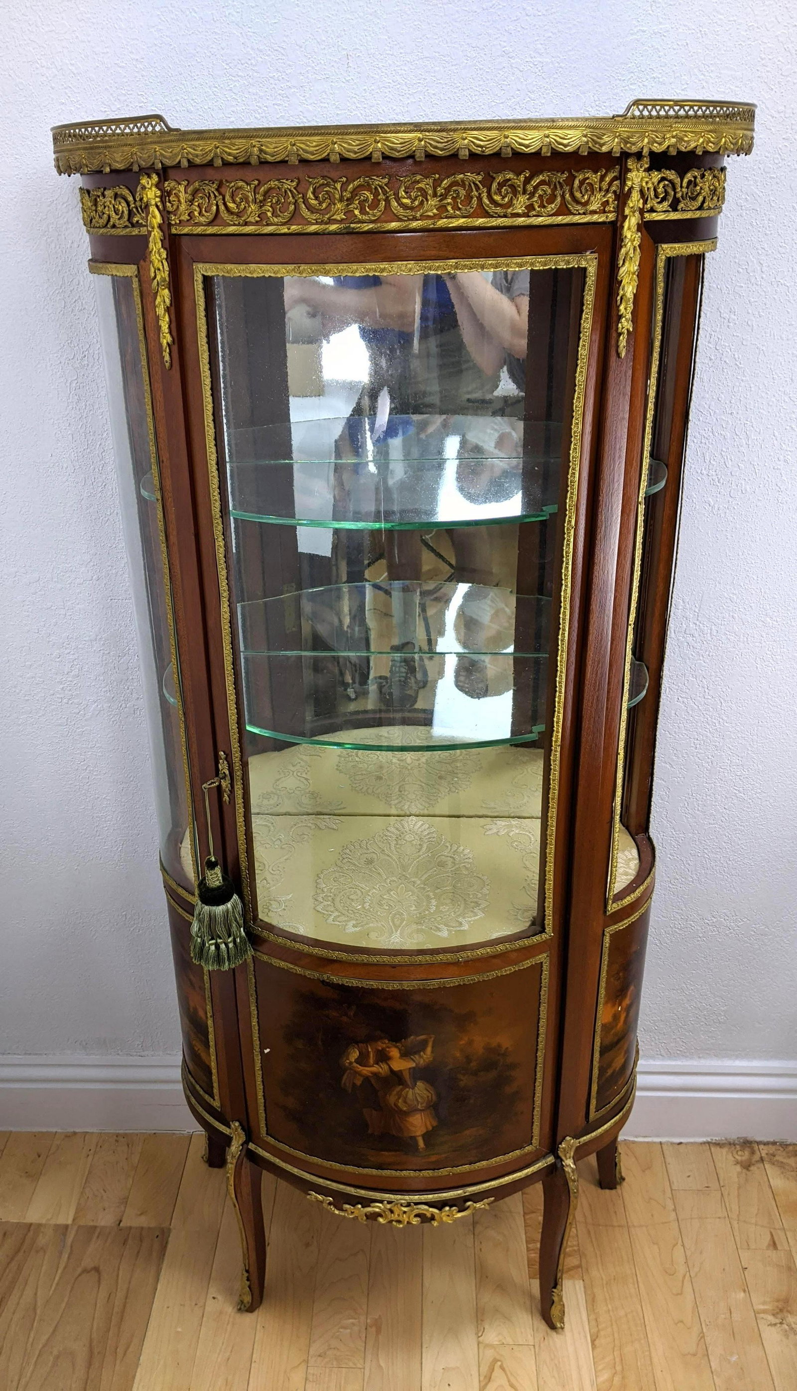 French Gilt Ormolu Vitrine Display Cabinet. Bowed glass: French Gilt Ormolu Vitrine Display Cabinet. Bowed glass door and sides. Hand painted landscape scenes with gilt metal trim.-- Dimensions: H: 59 inches: W: 26 inches: D: 13 inches ---