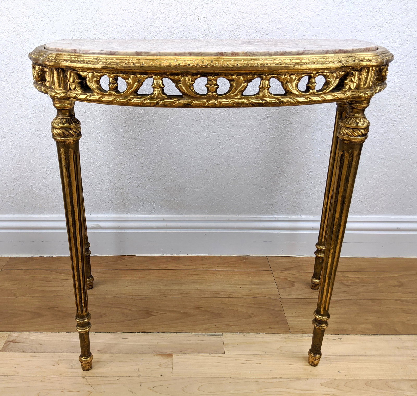 Pink Marble Top Demi Lune French Style Table. Tapered r: Pink Marble Top Demi Lune French Style Table. Tapered reeded legs. Open carved skirt-- Dimensions: H: 28.5 inches: W: 32 inches: D: 18 inches ---