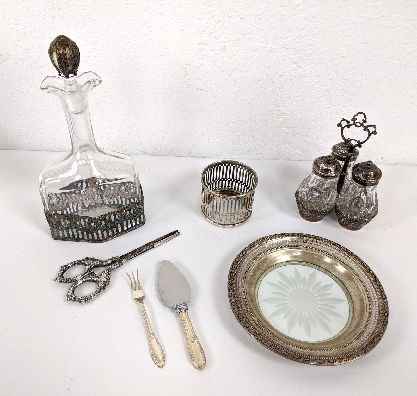 7pc Sterling Silver Crystal Antique Tableware Lot. Etch: 7pc Sterling Silver Crystal Antique Tableware Lot. Etched crystal decanter with sterling cherub design sleeve. 4 part sterling crystal shaker & mayonnaise server. Wine coaster, etc. Most marked Sterli