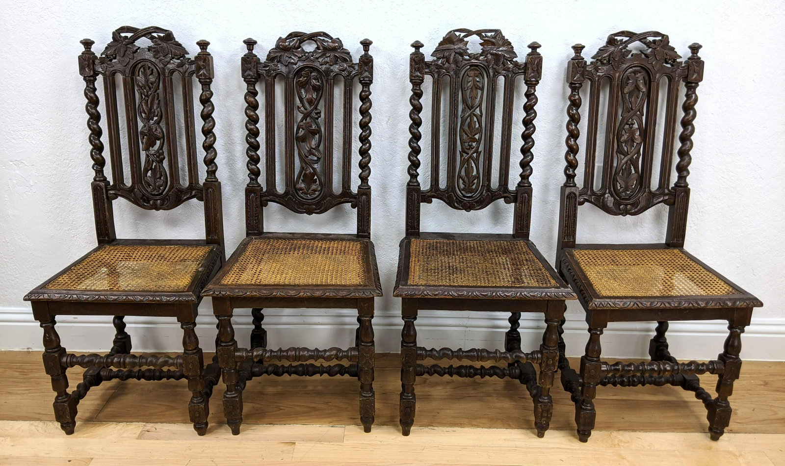 4 Antique Continental Carved Wood Side Chairs. Carved b: 4 Antique Continental Carved Wood Side Chairs. Carved backs with grape leaves and spiral column details. Twisted spindle legs. Caned seats.-- Dimensions: H: 42 inches: W: 17.5 inches: D: 16 inches ---