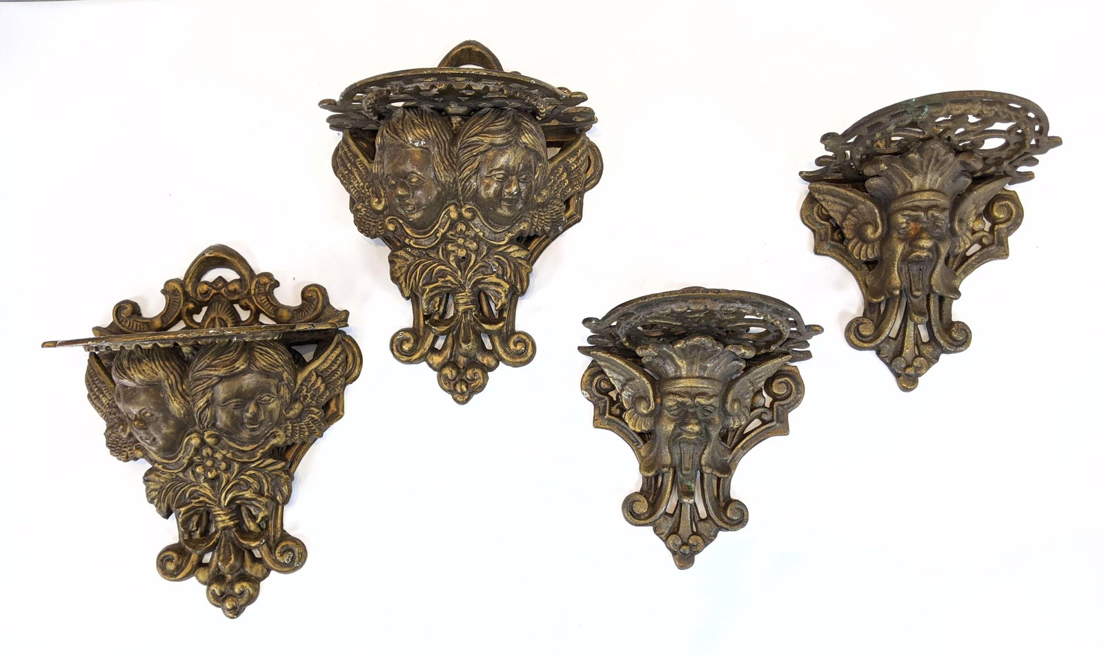 2 Pair Painted Cast Metal Wall Bracket Shelves. Figural: 2 Pair Painted Cast Metal Wall Bracket Shelves. Figurals with scroll design-- Dimensions: H: 12 inches: W: 9 inches: D: 7 inches ---