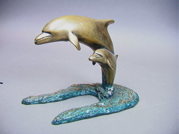 BOB BENNETT Bronze Sculpture Two Leaping Dolphins: BOB BENNETT Bronze Sculpture Two Leaping Dolphins. Heavy bronze sculpture with blue green patina accents. Unsigned. Dimensions: H: 7.5 inches: W: 11 inches: D: 5.5 inches Condition (General) Please co