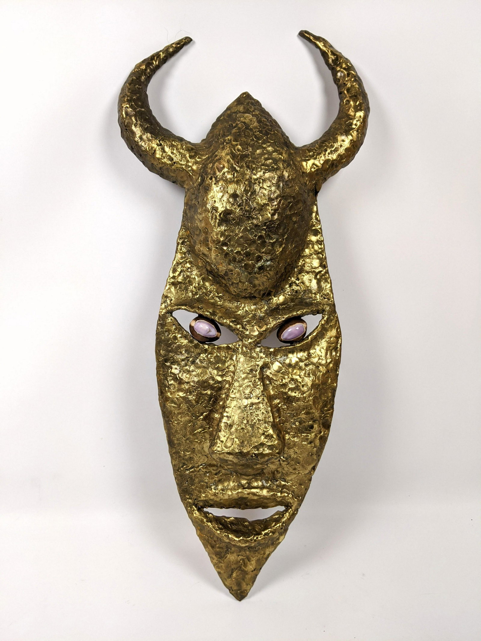 Welded and Hammered Mask Sculpture. Horned mask set wit: Welded and Hammered Mask Sculpture. Horned mask set with stones. -- Dimensions: H: 23 inches: W: 10 inches: D: 2 inches ---