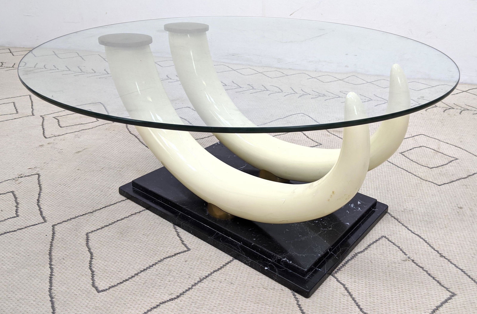 Decorator Faux Tusk Coffee Cocktail Table. Glass Top. B: Decorator Faux Tusk Coffee Cocktail Table. Glass Top. Brass mounted. -- Dimensions: H: 17 inches: W: 36 inches: D: 36 inches ---