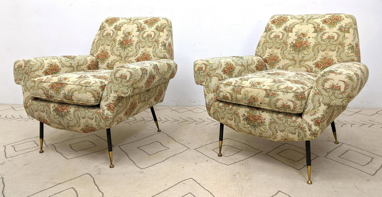 Pr Italian Modern Lounge Chairs. Floral Upholstery. Bro: Pr Italian Modern Lounge Chairs. Floral Upholstery. Broad rolled arms. Black metal drumstick legs with gold cap feet-- Dimensions: H: 32 inches: W: 33 inches: D: 31 inches ---