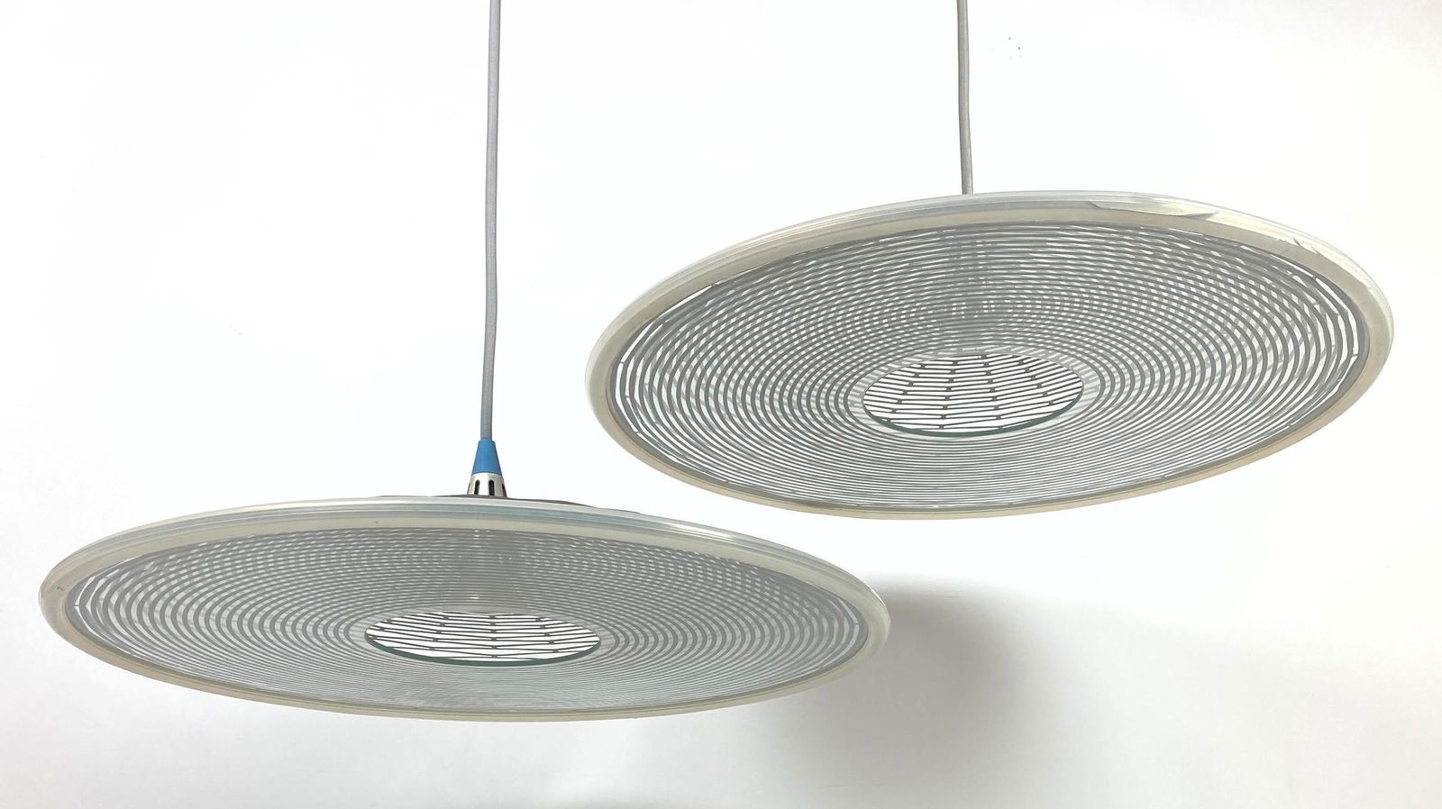Pair Artemide Modern Flying Saucer Pendant Lamps.: Pair Artemide Modern Flying Saucer Pendant Lamps. Patterned metal and glass. Signed -- Dimensions: H: 63 inches: W: 20 inches: D: 20 inches ---