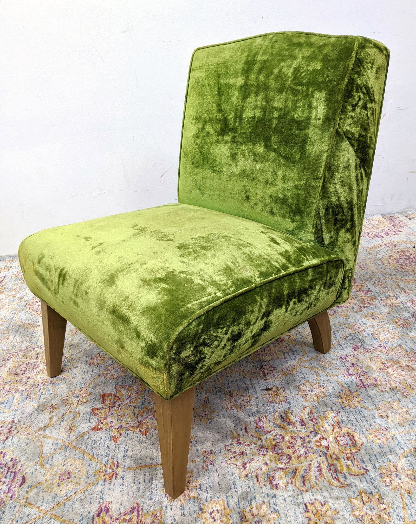Green Velvet Upholstered Modernist Slipper Chair. Taper: Green Velvet Upholstered Modernist Slipper Chair. Tapered square blond wood legs-- Dimensions: H: 31 inches: W: 25 inches: D: 28 inches ---