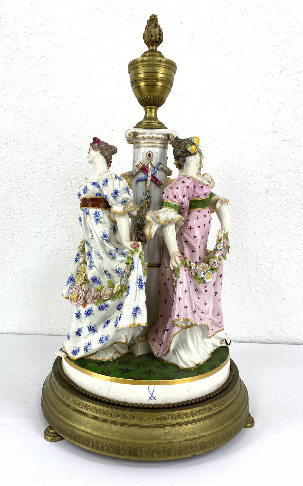 Porcelain Figural Grouping with Bronze Mounts. Meissen: Porcelain Figural Grouping with Bronze Mounts. Meissen mark. Bronze base rim and urn finial.-- Dimensions: H: 24 inches: W: 13.5 inches: D: 13.5 inches ---