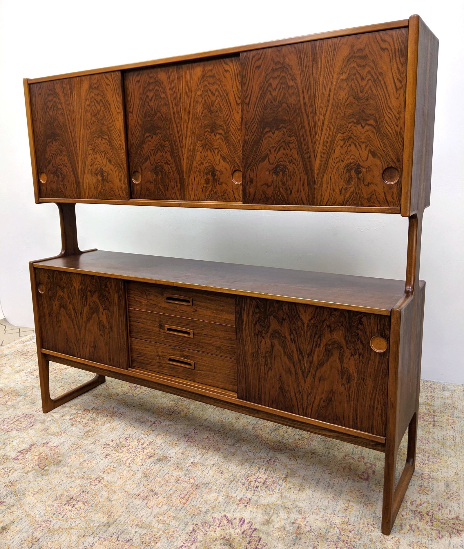Nicely figured Rosewood Credenza Hutch. Lower cabinet r: Nicely figured Rosewood Credenza Hutch. Lower cabinet raised on open side legs. Upper Cabinet with sliding doors. Finished back. Again, Beautiful wood. -- Dimensions: H: 68.5 inches: W: 72.5 inches: D