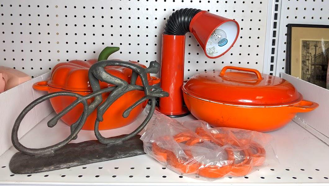 Metal Biker Sculpture and Red Housewares. Adjustable l: Metal Biker Sculpture and Red Housewares. Adjustable lamp. Baking lidded pots.-- Dimensions: ---