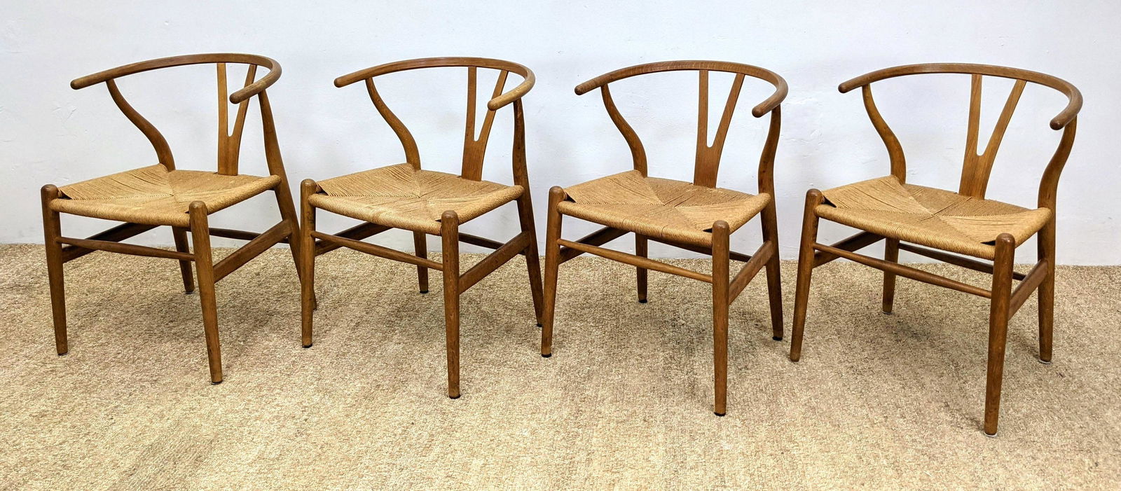 Set 4 HANS WEGNER Wishbone Dining Chairs. Stylish Iconi: Set 4 HANS WEGNER Wishbone Dining Chairs. Stylish Iconic Frames with woven rush seats. Marked Made in Denmark by Karl Hansen & Son; Odense. -- Dimensions: H: 28.5 inches: W: 20 inches: D: 24 inches --