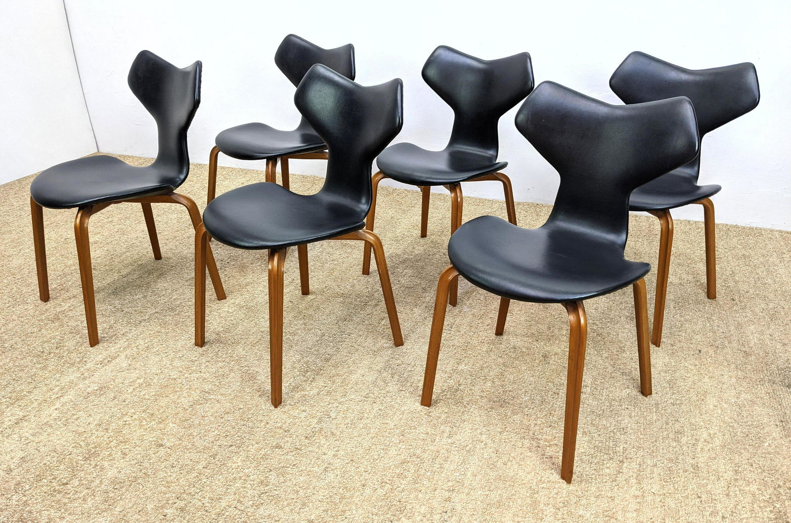 Set 6 FRITZ HANSEN Modernist Dining Chairs. GRAND PRIX: Set 6 FRITZ HANSEN Modernist Dining Chairs. GRAND PRIX Dining Chairs with black leather seats and sculptural laminated wood legs. Label. Danish Modern Design. -- Dimensions: H: 31 inches: W: 18 inches