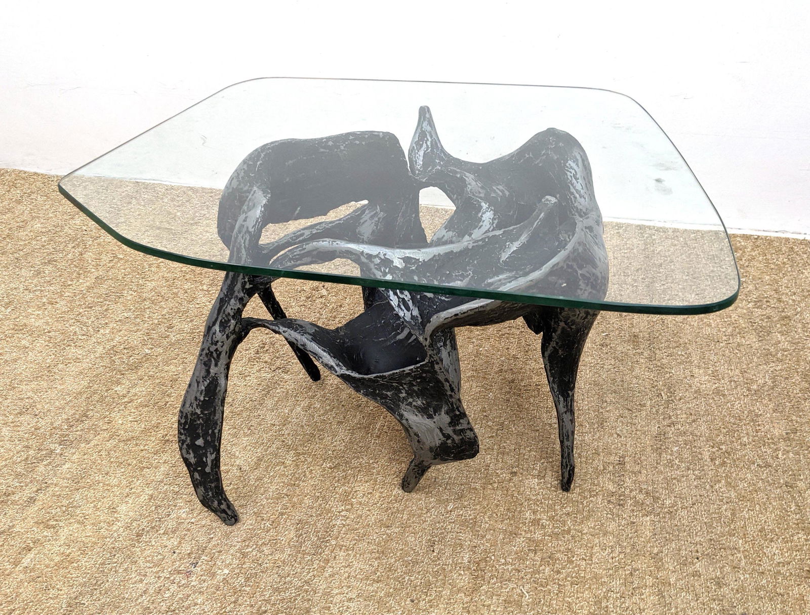 Brutalist Metal Base Glass Top Table. Paul Evans Style.: Brutalist Metal Base Glass Top Table. Paul Evans Style. Sculptural base with black finish. -- Dimensions: H: 18 inches: W: 32 inches: D: 28 inches ---