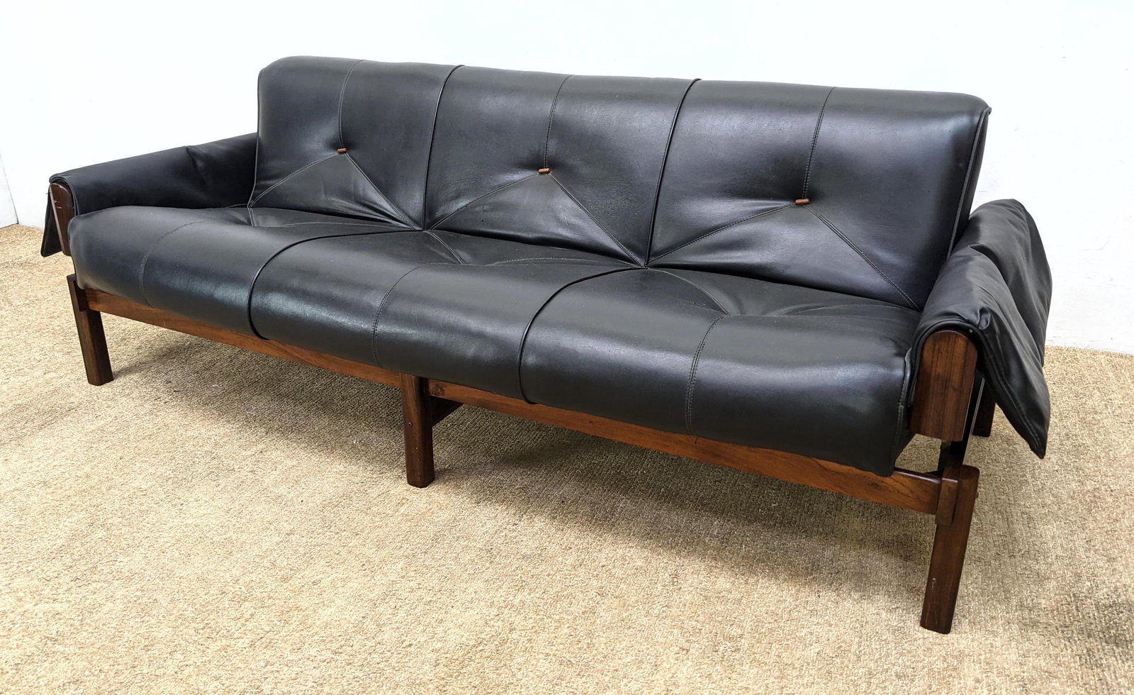 PERCIVAL LAFER Modernist Rosewood, Leather Sofa Couch.: PERCIVAL LAFER Modernist Rosewood, Leather Sofa Couch. Tufted black leather cushions on stylish rosewood frame. Model MP-013. -- Dimensions: H: 27 inches: W: 74 inches: D: 33 inches ---