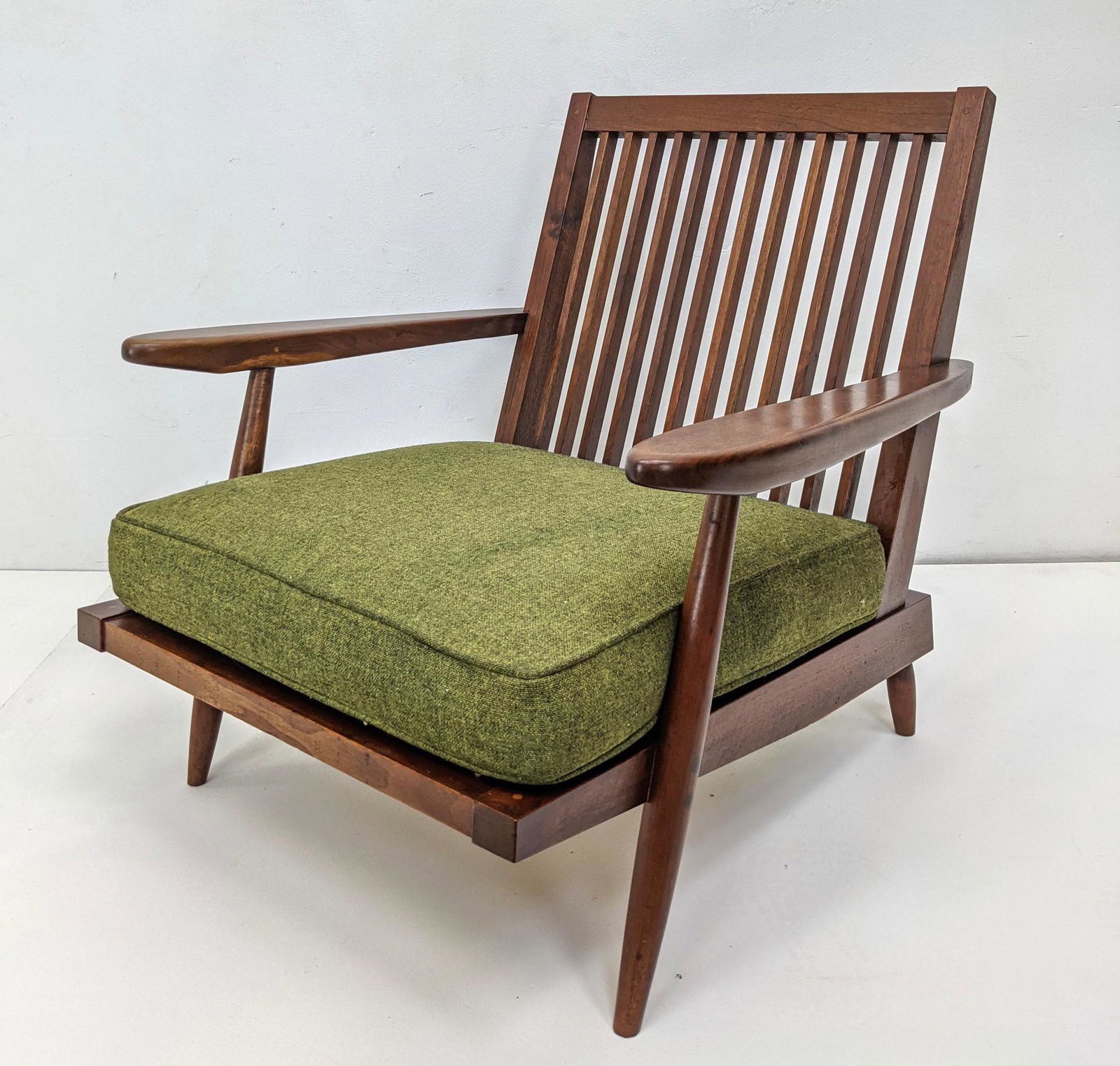 Original GEORGE NAKASHIMA Walnut Lounge Chair. Angle Sl: Original GEORGE NAKASHIMA Walnut Lounge Chair. Angle Slat Back with two paddle arms. Has cushions. Single Owner. Note: This item and all the George Nakashima items from lot 695 though 742 were acquire