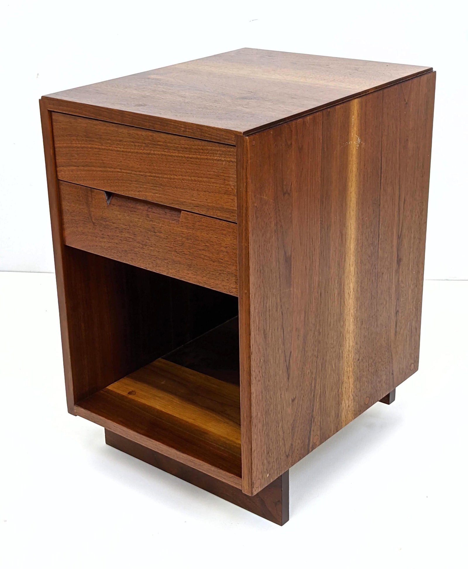 In the style of GEORGE NAKASHIMA Night Stand: In the style of GEORGE NAKASHIMA American Walnut Night Stand. Two Drawer with open storage cubby. Note- This is is being sold as "in the style" of George Nakashima. While the item was part of the Mezg