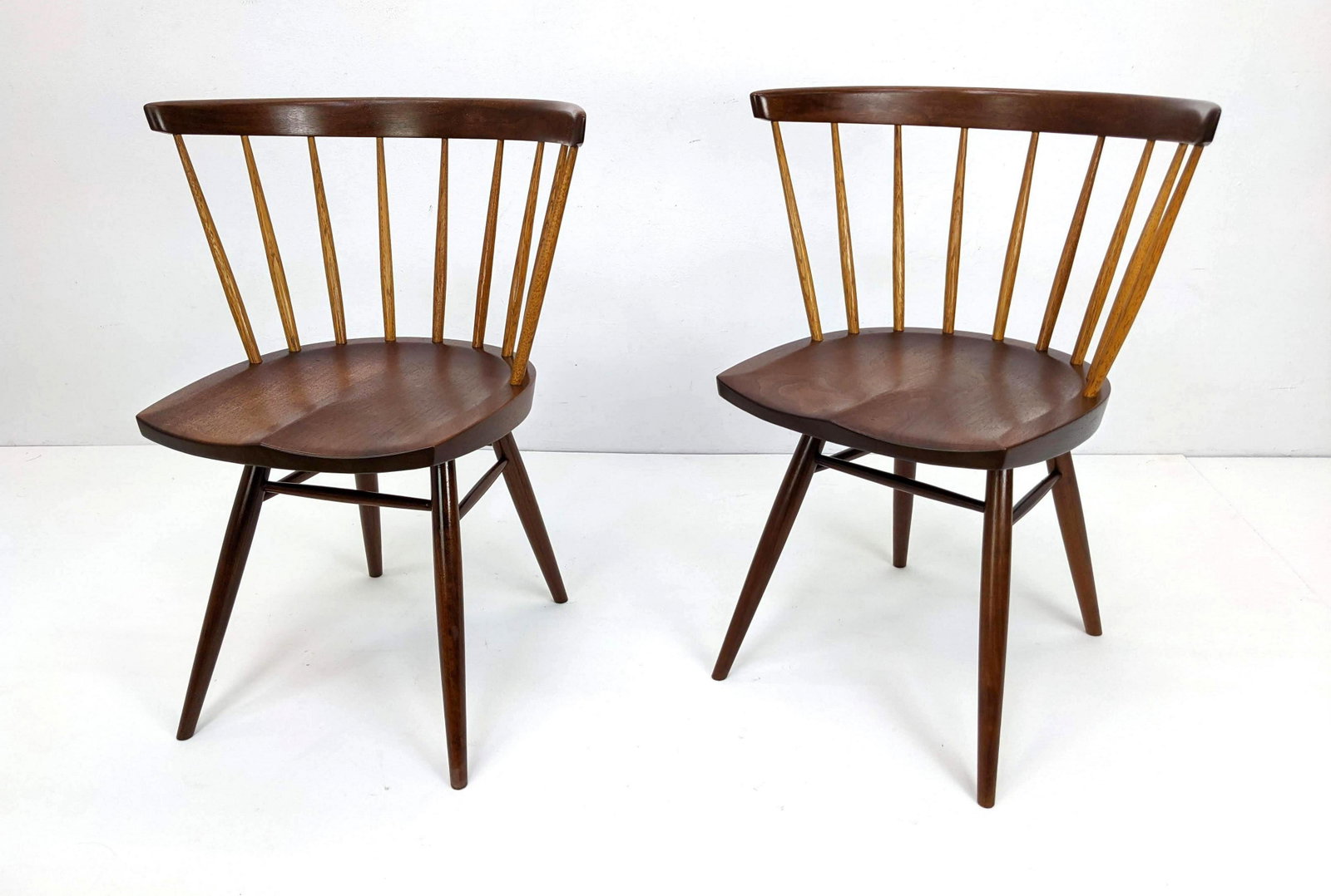 Pr GEORGE NAKASHIMA Dining Chairs with order card: Pr GEORGE NAKASHIMA American Walnut Dining Chairs. This item will come with a copy of the original order card from Nakashima Studios from 1961. Originally for four chairs lots 720 and 721. Bowed backr