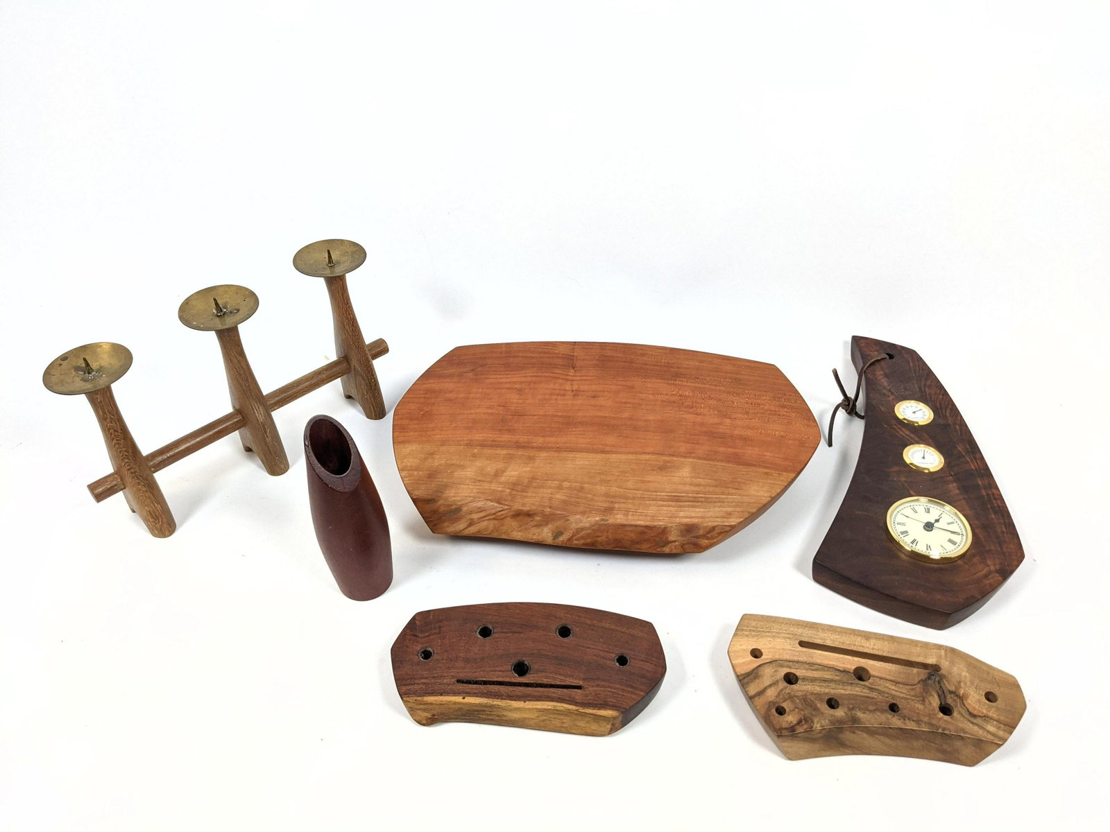 6pc Collection Of Artisan Wood Items. One MARTINI'S WOO: 6pc Collection Of Artisan Wood Items. One MARTINI'S WOODWORK footed Serving Cheese Board. Two MARTINI'S Business card and Pen Holders. Wood Plaque with Clock. Vase. Brass and Wood Candleholder-- Dimen