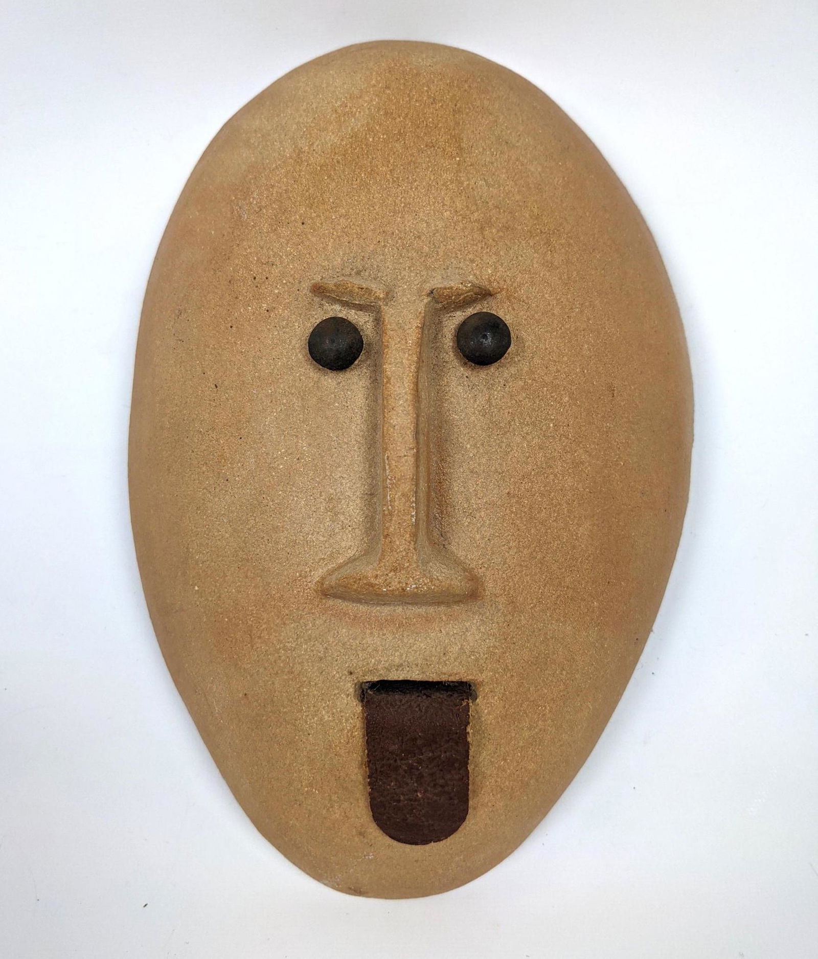 BENNINGTON POTTERS Ceramic Face Wall Hanging. DAVID GIL: BENNINGTON POTTERS Ceramic Face Wall Hanging. DAVID GIL, designer. Leather tongue. Marked. -- Dimensions: H: 11.25 inches: W: 7.5 inches: D: 3.5 inches ---