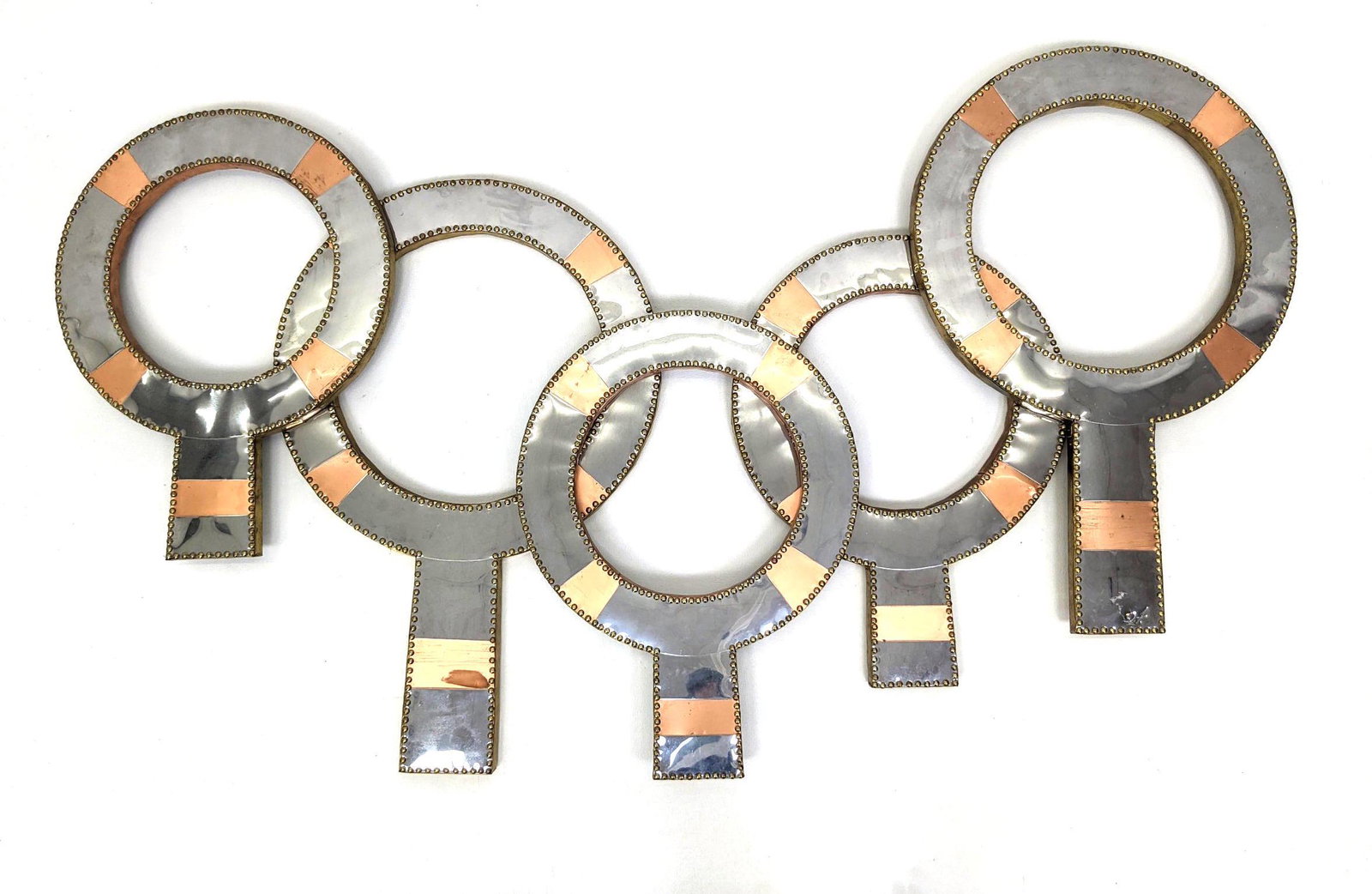 Don FREEDMAN Metal Wall Sculpture. Repeating Mixed Meta: Don FREEDMAN Metal Wall Sculpture. Repeating Mixed Metal Images with gold stud trim. Initialed. Metal over wood.-- Dimensions: H: 33 inches: W: 56 inches: D: 1.5 inches ---