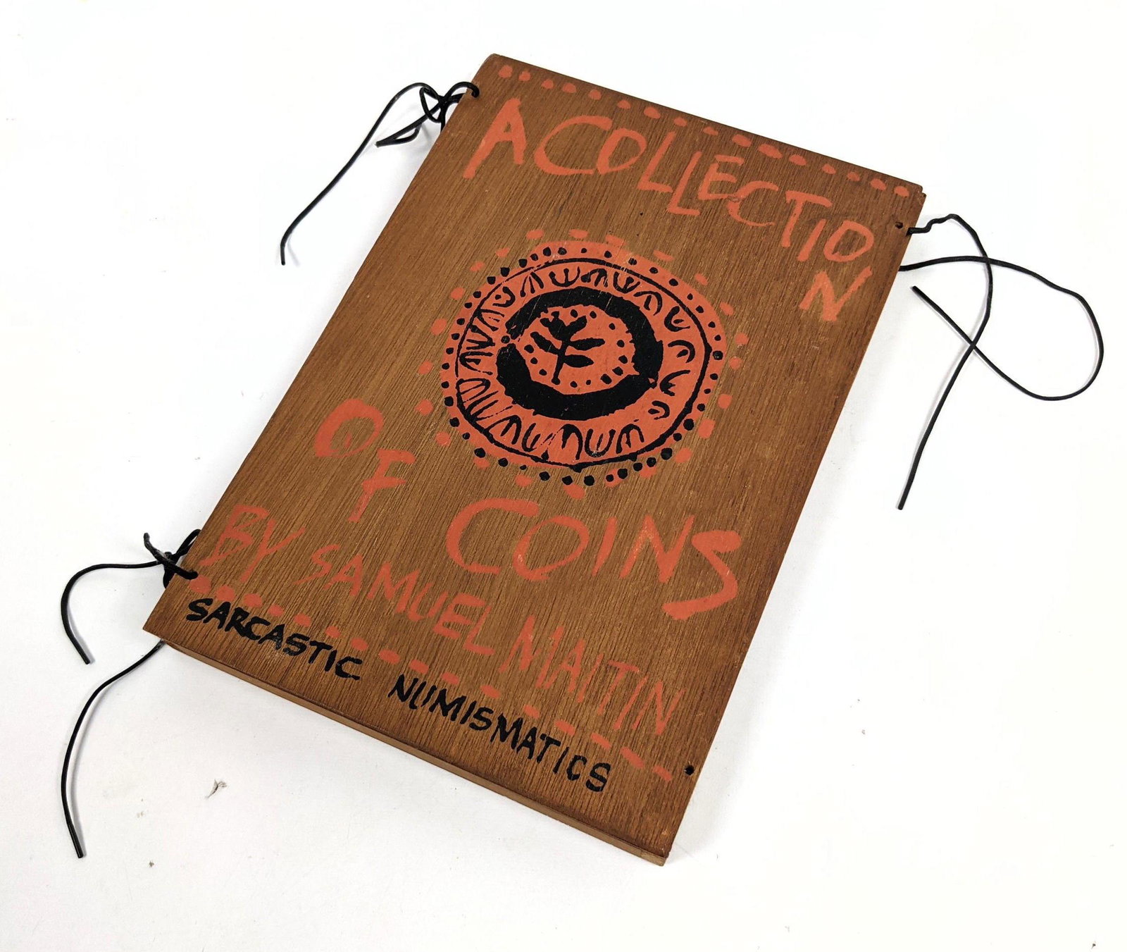 A Collection of Coins by SAM Samuel MAITIN Book. Penc: A Collection of Coins by SAM Samuel MAITIN Book. Pencil signed; dated 1967. #6/20. Subtitled "Sarcastic Numismatics: the price of money is Too High" Wood box cover with collection of ironic coins and 