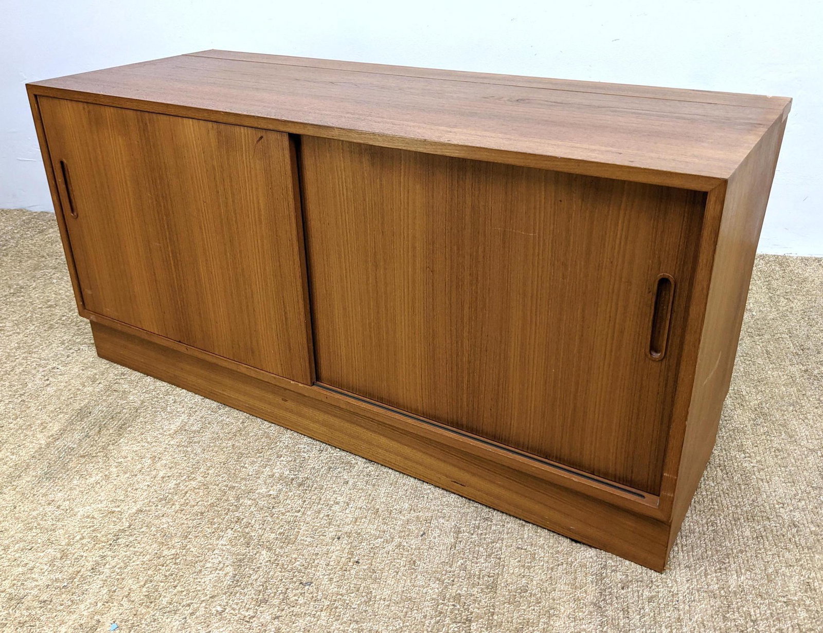 Danish Modern Teak Credenza. Sliding Door Cabinet on Pl: Danish Modern Teak Credenza. Sliding Door Cabinet on Platform Base.-- Dimensions: H: 26.5 inches: W: 54.5 inches: D: 21 inches ---